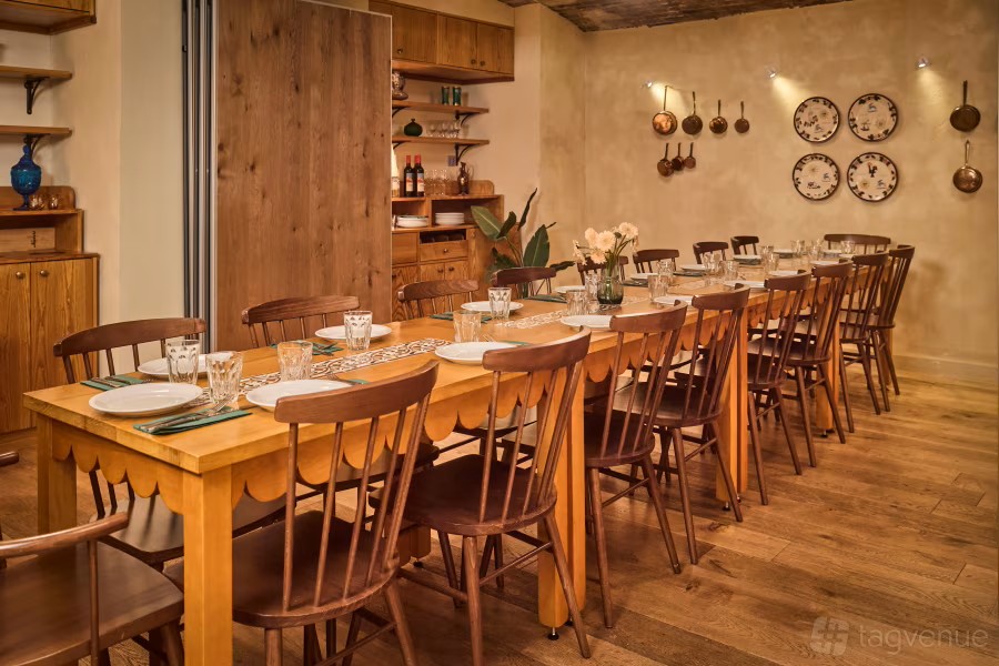 Cozy private dining room with long wooden table for intimate gatherings at Casa Mayfair.