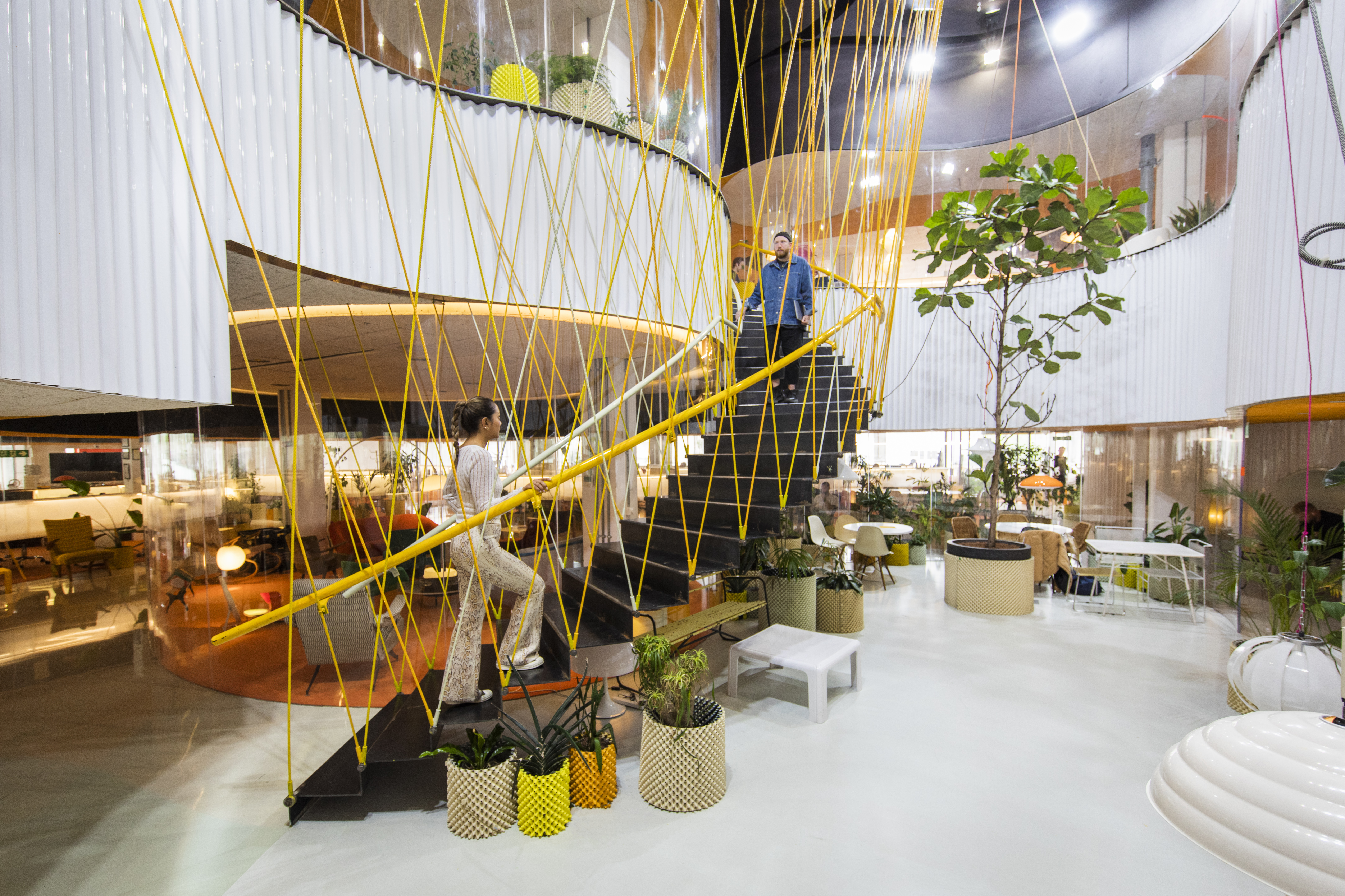 Modern event space with vibrant decor and unique stairway in Second Home Spitalfields.