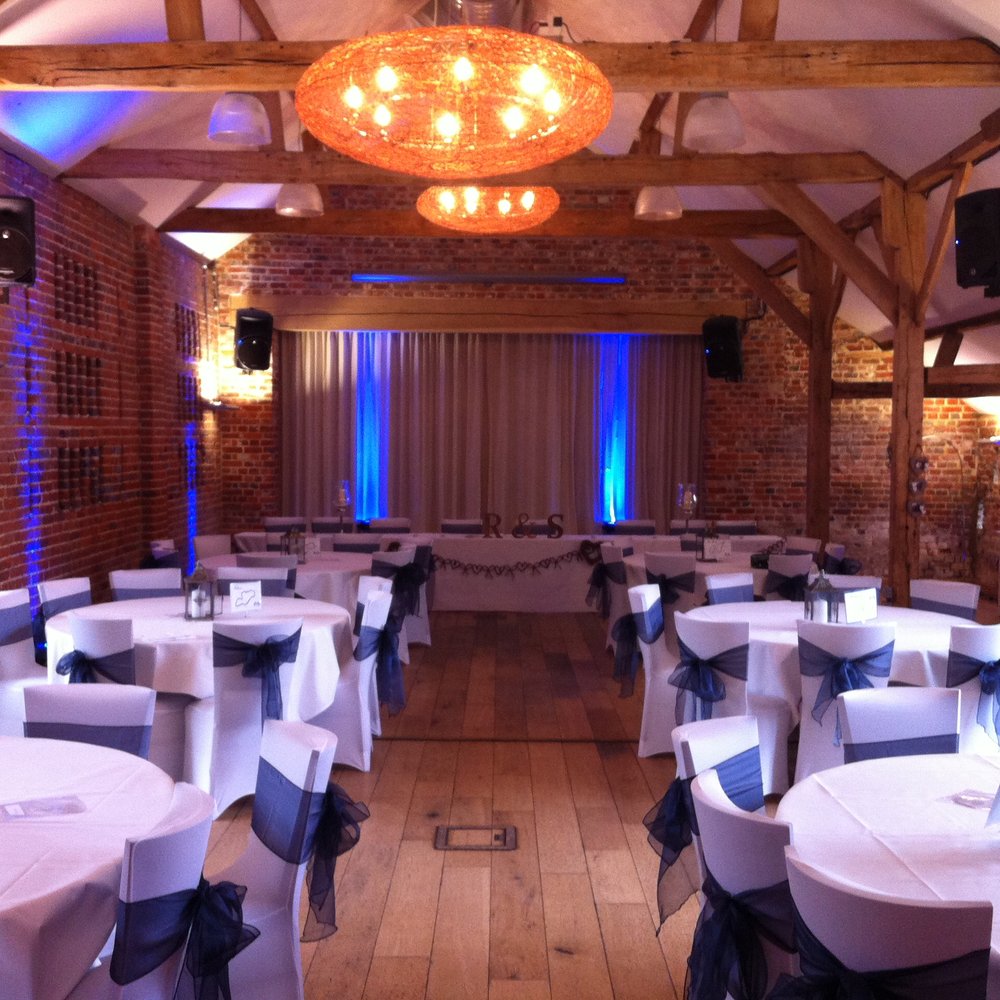 Elegant Main Hall event space with round tables, ideal for corporate gatherings and celebrations.