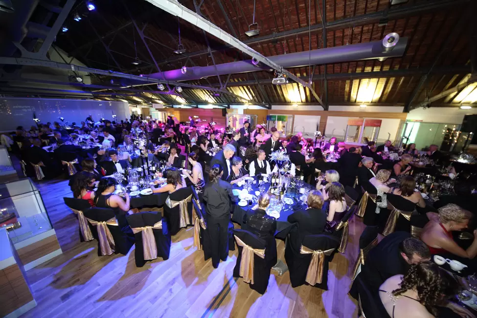 Elegant corporate gala at Warehouse Gallery, showcasing sophisticated decor and networking ambiance.