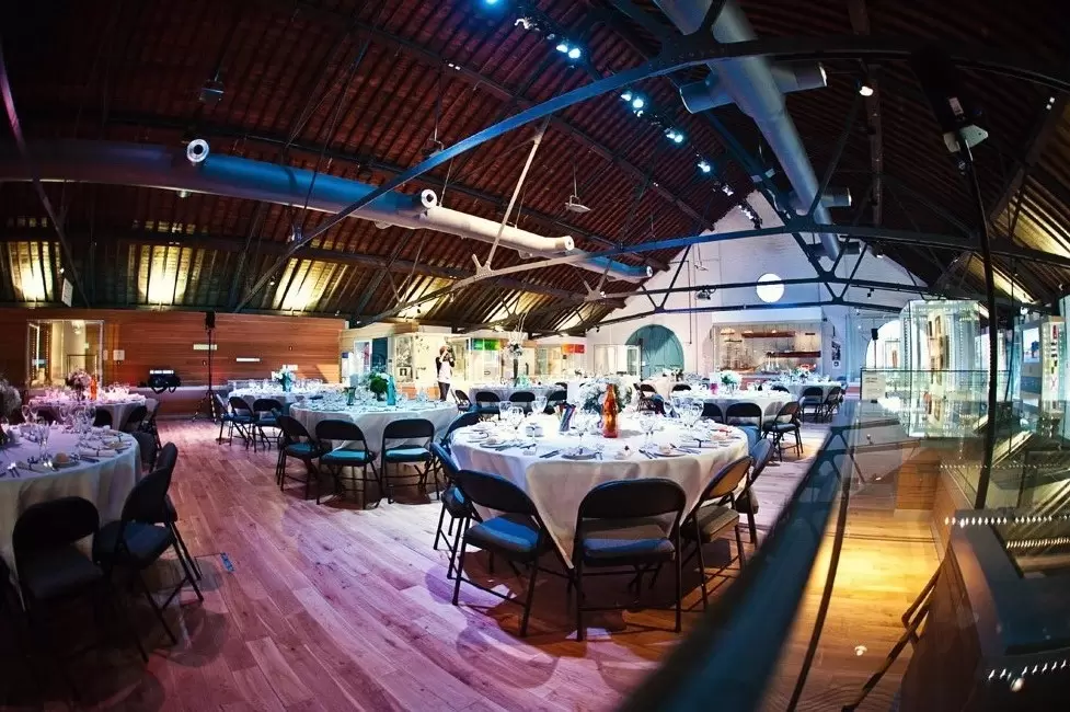 Elegant Warehouse Gallery for upscale corporate events and weddings with round tables.