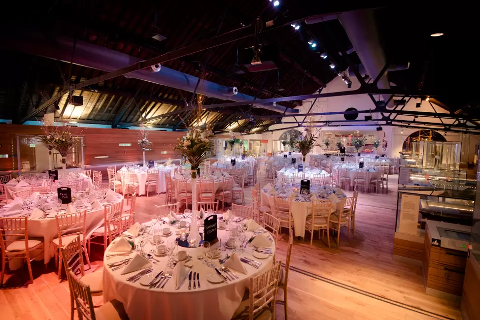 Elegant round tables in the Warehouse Gallery, ideal for upscale weddings and corporate events.