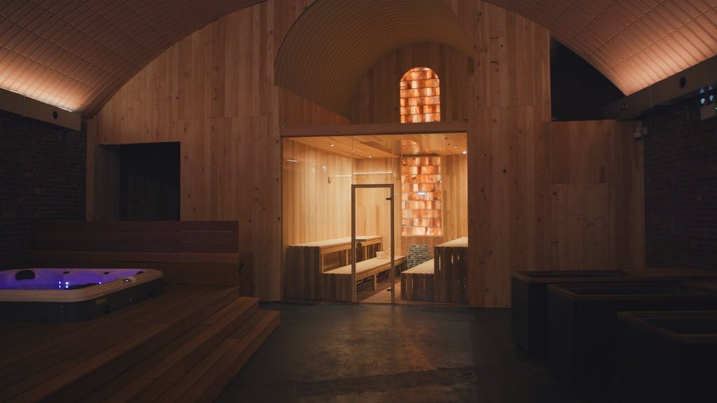 WellNest Wellness Centre with wooden panels, sauna, and hot tub for retreats.