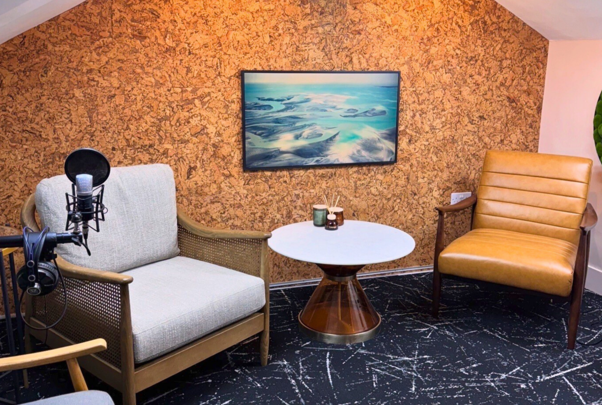 Cozy podcast studio with modern seating and microphone for hybrid events in Harpenden.