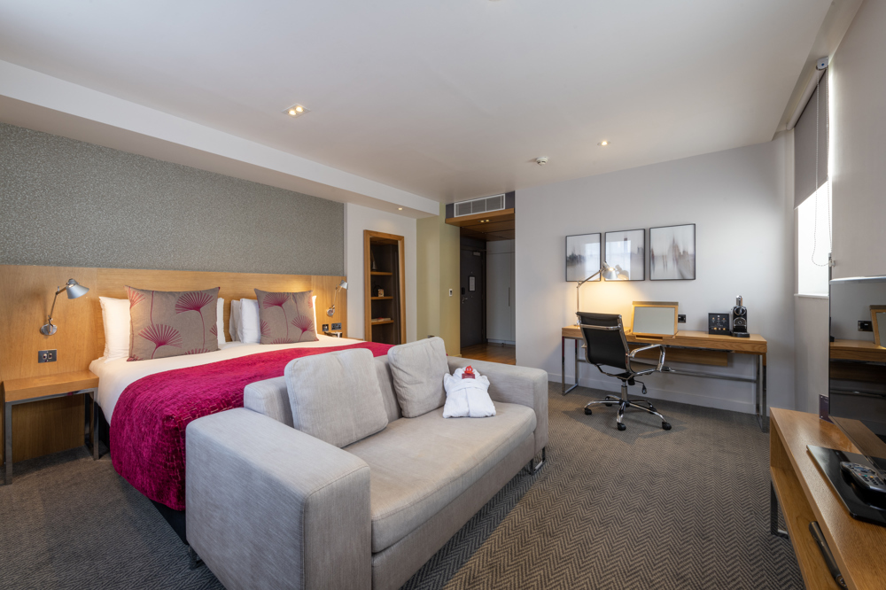 Comfortable hotel bedroom at Apex Temple Court for business travelers and events.