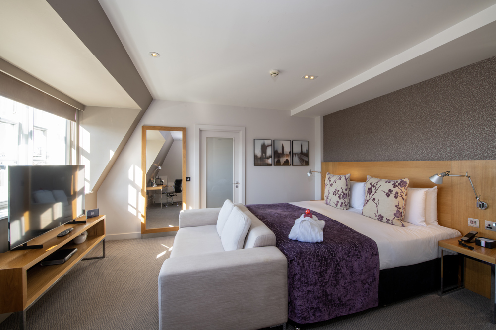 Apex Temple Court Hotel spacious room with modern decor for events and meetings.