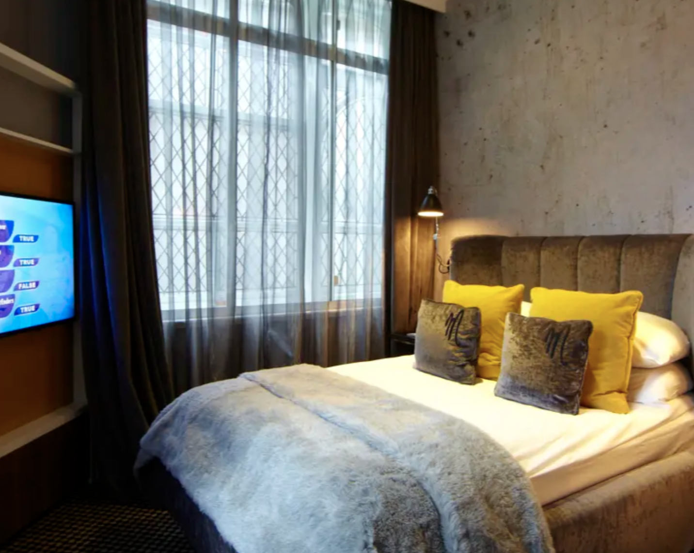 Stylish hotel bedroom in Malmaison London, perfect for event attendees and relaxation.