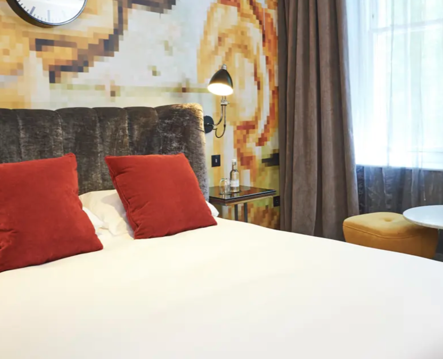 Stylish Malmaison London hotel room with comfortable bed for corporate retreats and events.