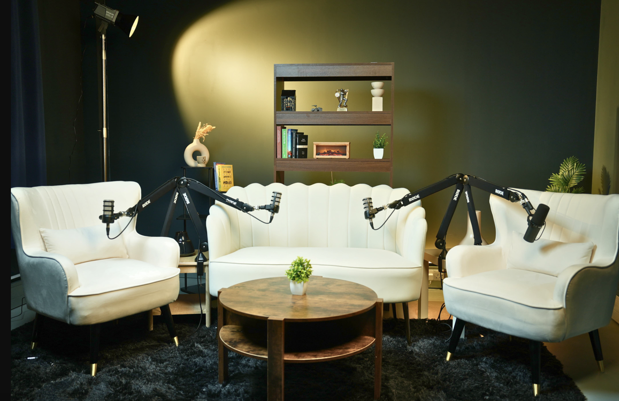 Stylish podcast recording studio with plush seating and microphones in London.