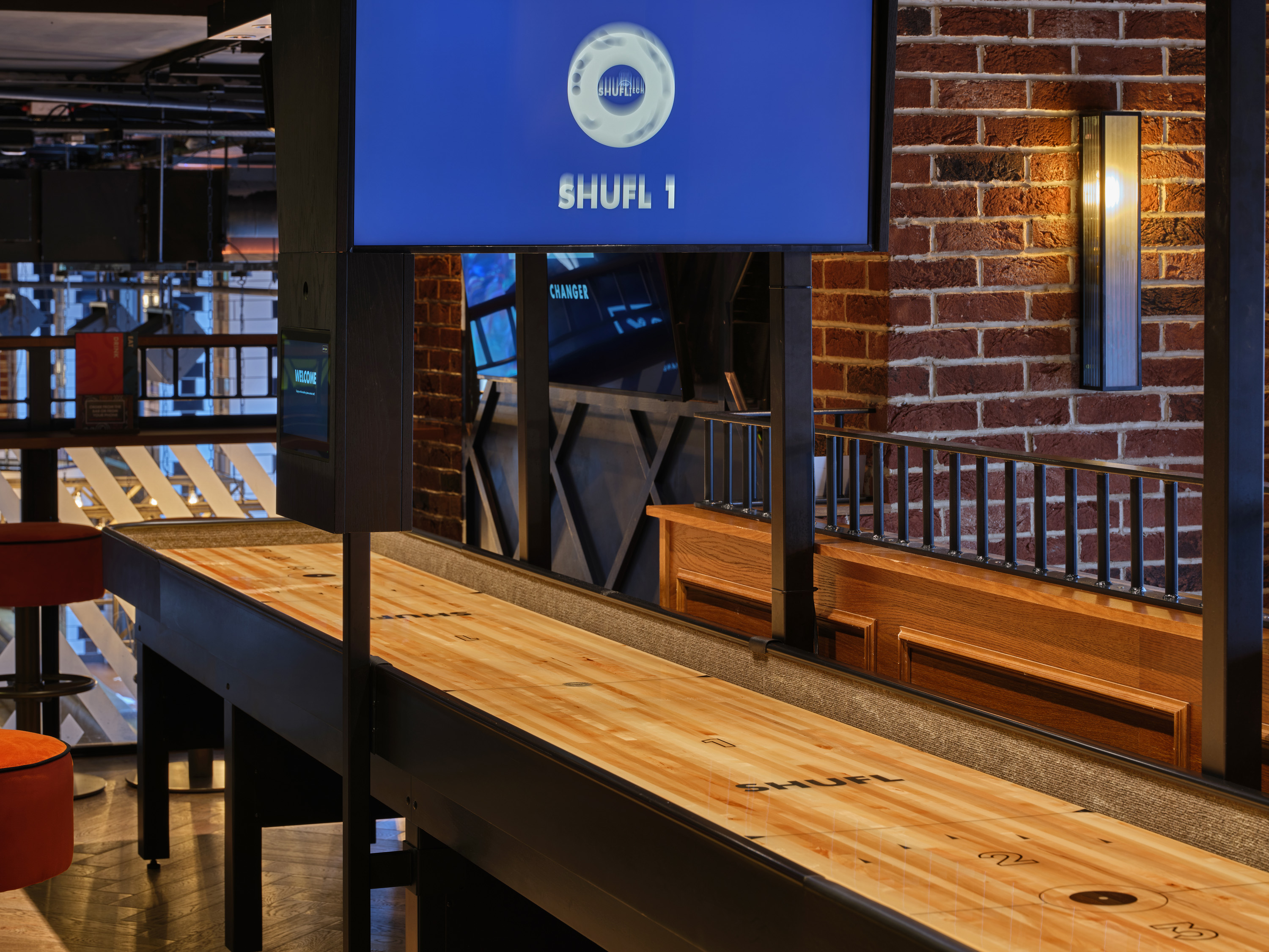 Sleek shuffleboard table in BOX Piccadilly for networking and events.