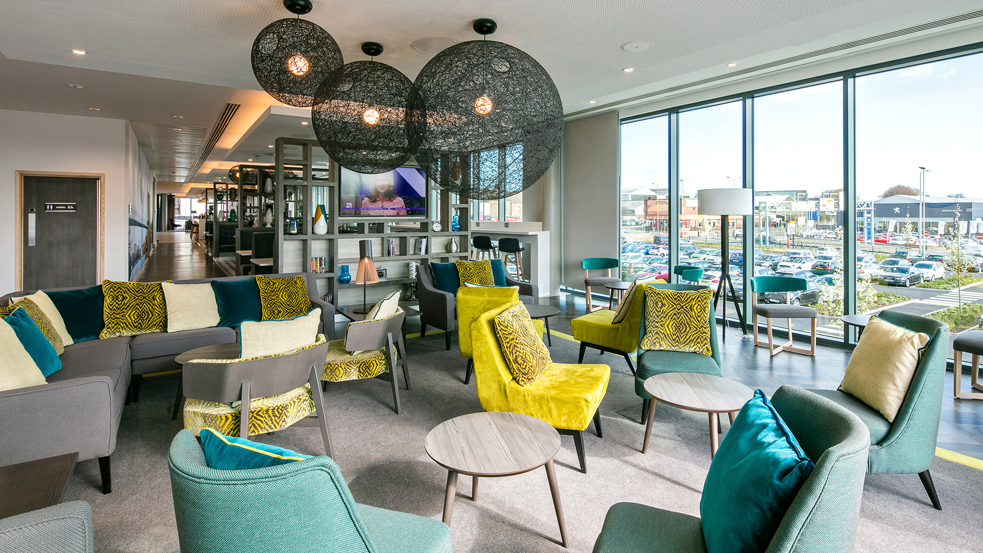 Modern lounge area at Hampton by Hilton Stockton for networking events and informal meetings.