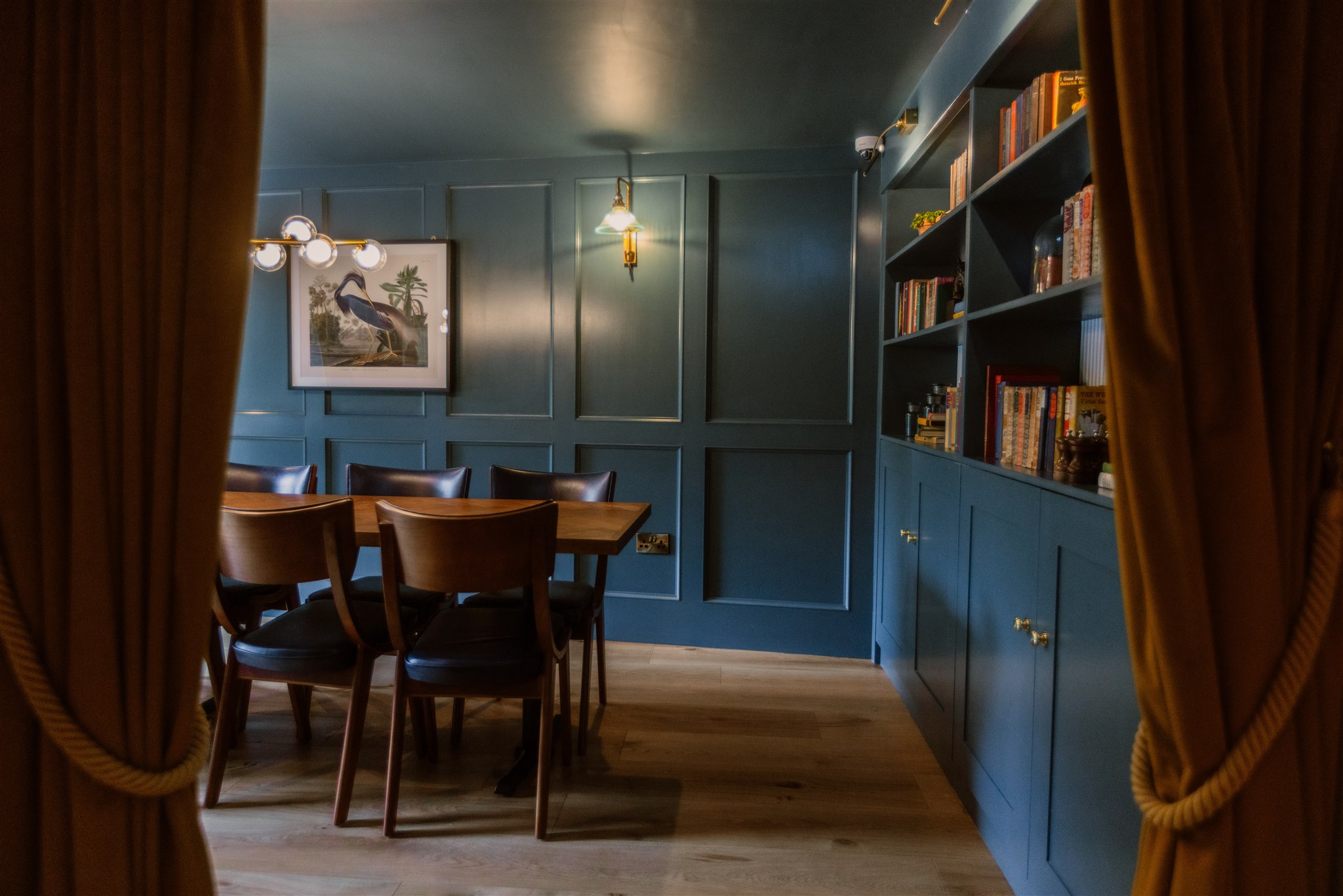 Elegant Olive Room Function Space with teal walls, perfect for meetings and gatherings.