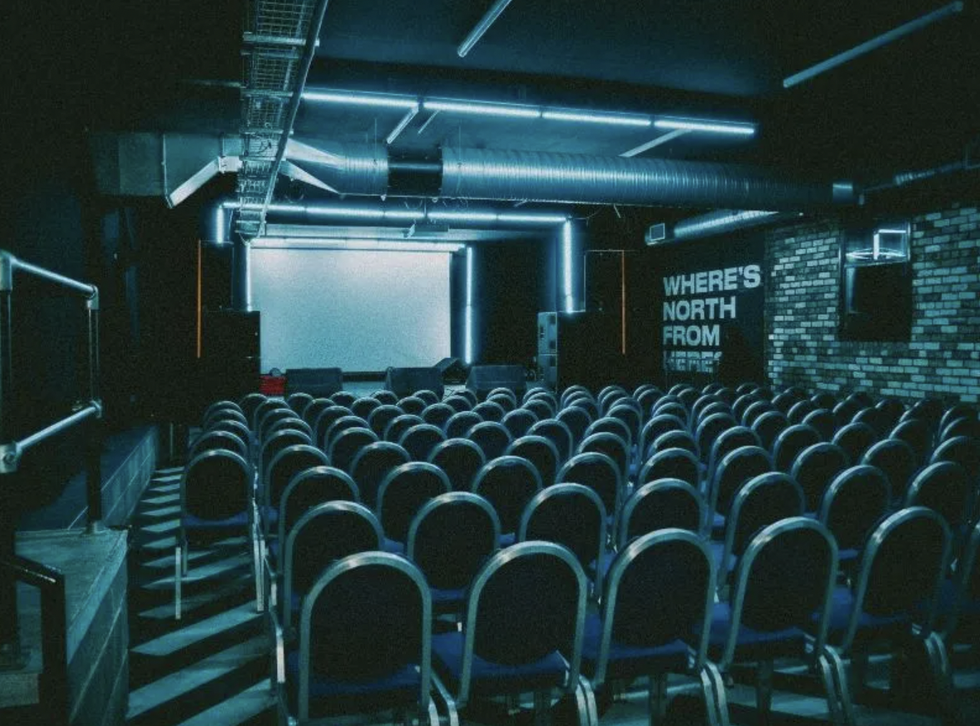 Modern event space at The Grove, Newcastle with tiered seating for corporate presentations.