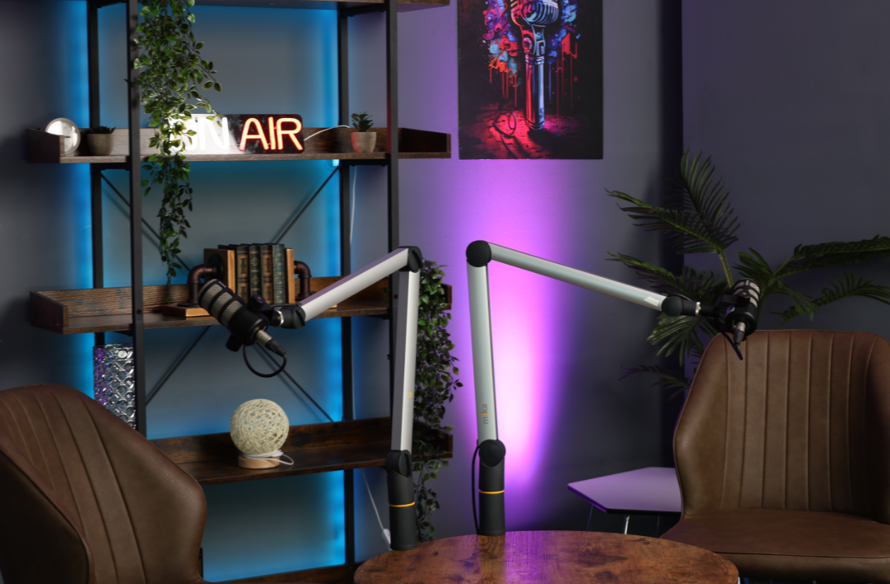 Modern podcast studio with microphone stands and ambient lighting for engaging events.