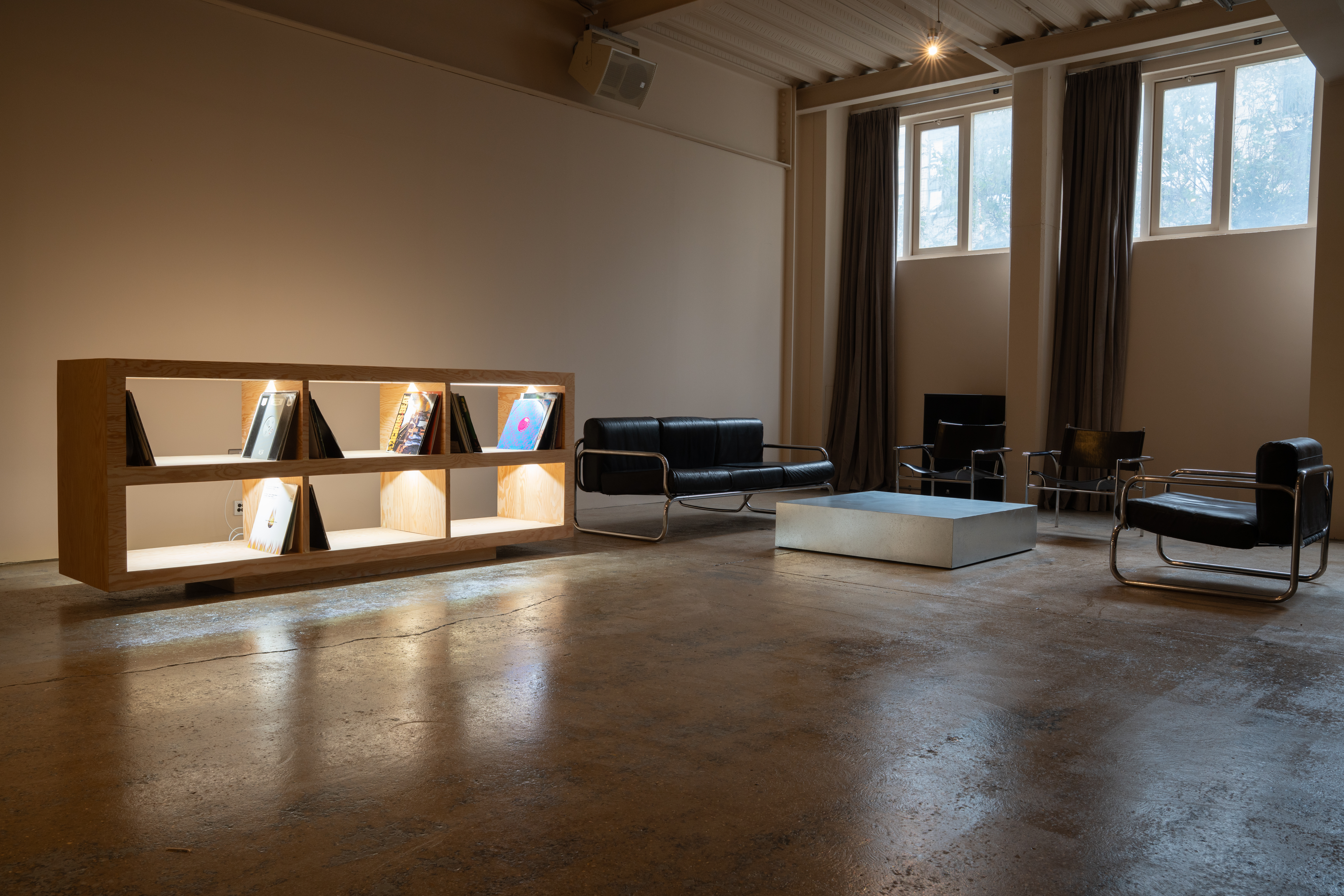 Minimalist meeting space in London photography studio with sleek furniture and soft lighting.