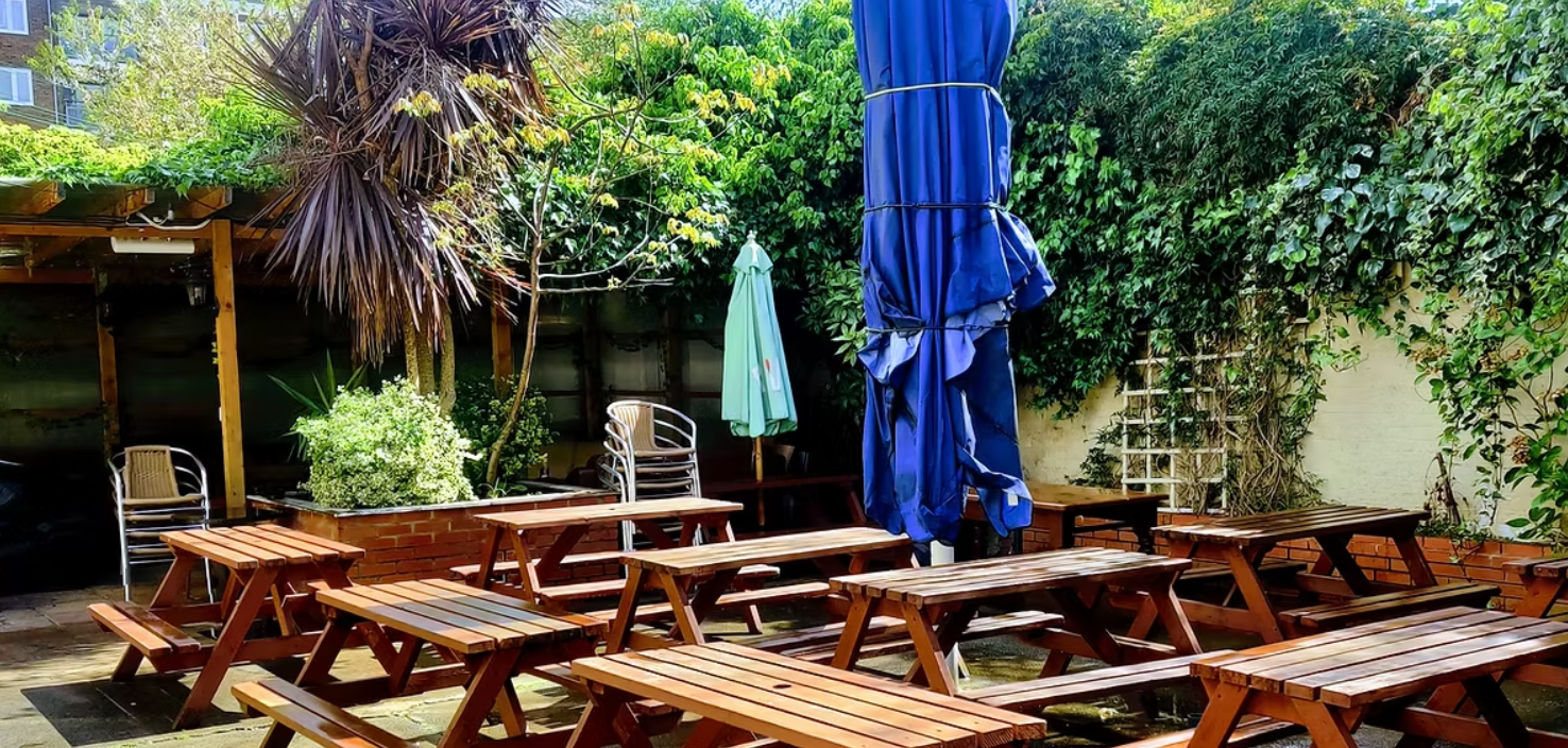 Outdoor venue at Whole Pub, Stag's Head Hoxton, with picnic tables for casual events.