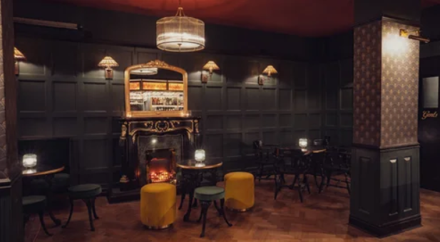 Elegant event space at 135 Bar & Lounge, featuring cozy fireplace, ideal for gatherings.