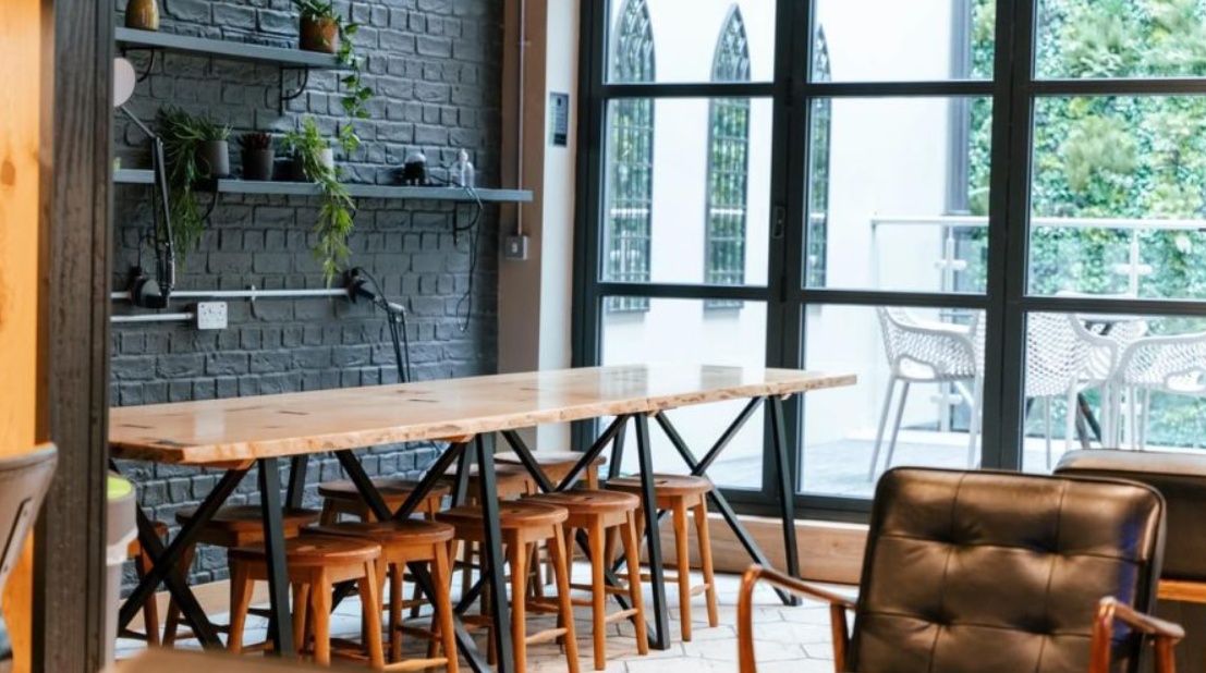 Sleek meeting space with wooden table for creative brainstorming sessions in Film + TV Charity