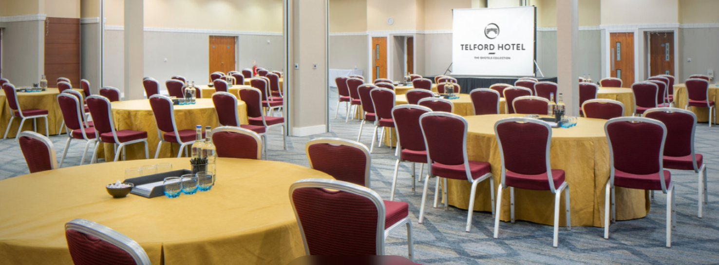 Coalport Suite meeting space with round tables, ideal for conferences and networking events.