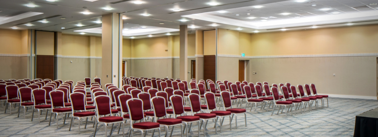 Coalport Suite conference room with red and gold chairs, ideal for workshops and presentations.