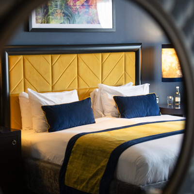Elegant hotel room with plush bed in Malmaison Newcastle, ideal for corporate retreats.