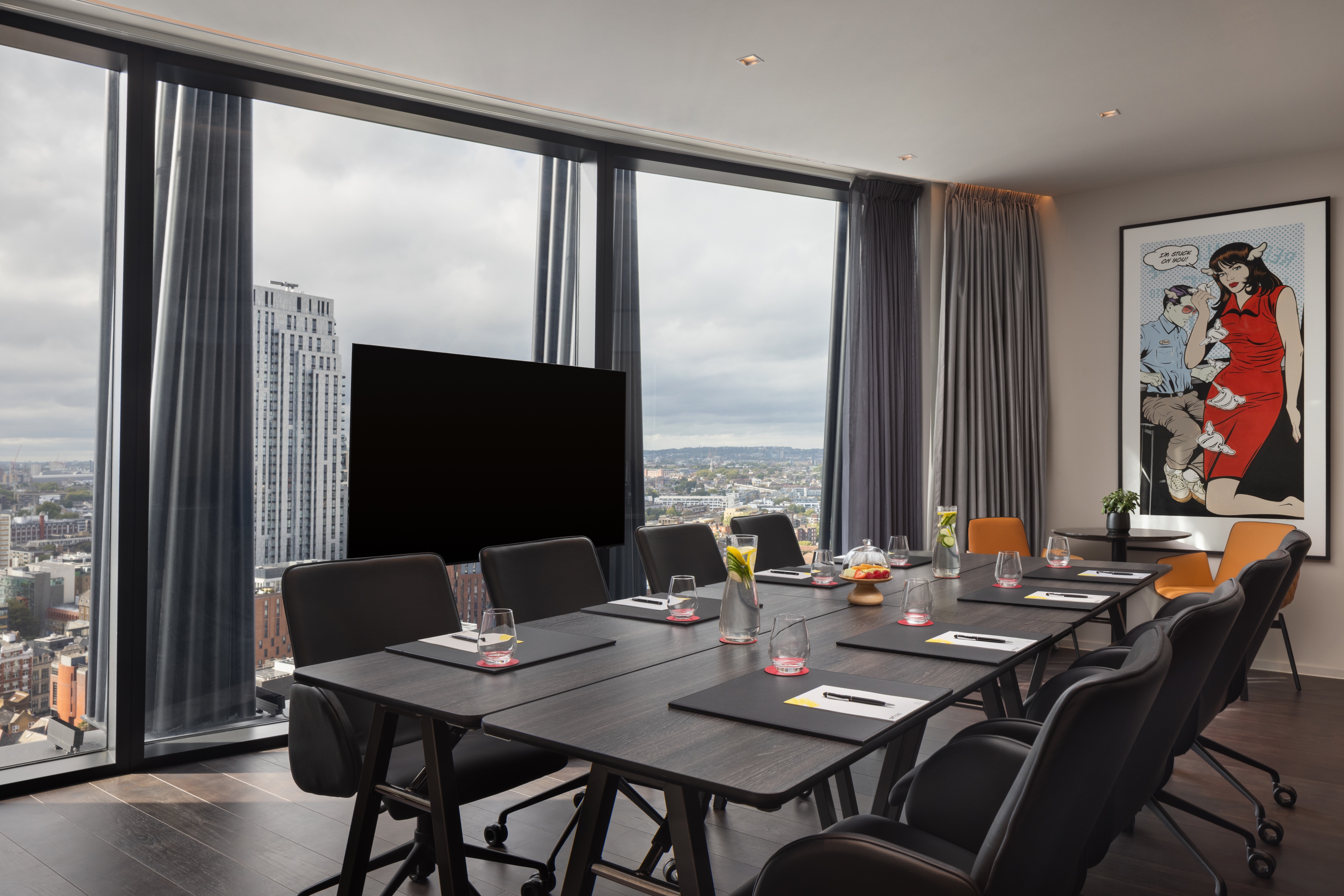 Modern meeting room with views and large screen for corporate events in art'otel London Hoxton.