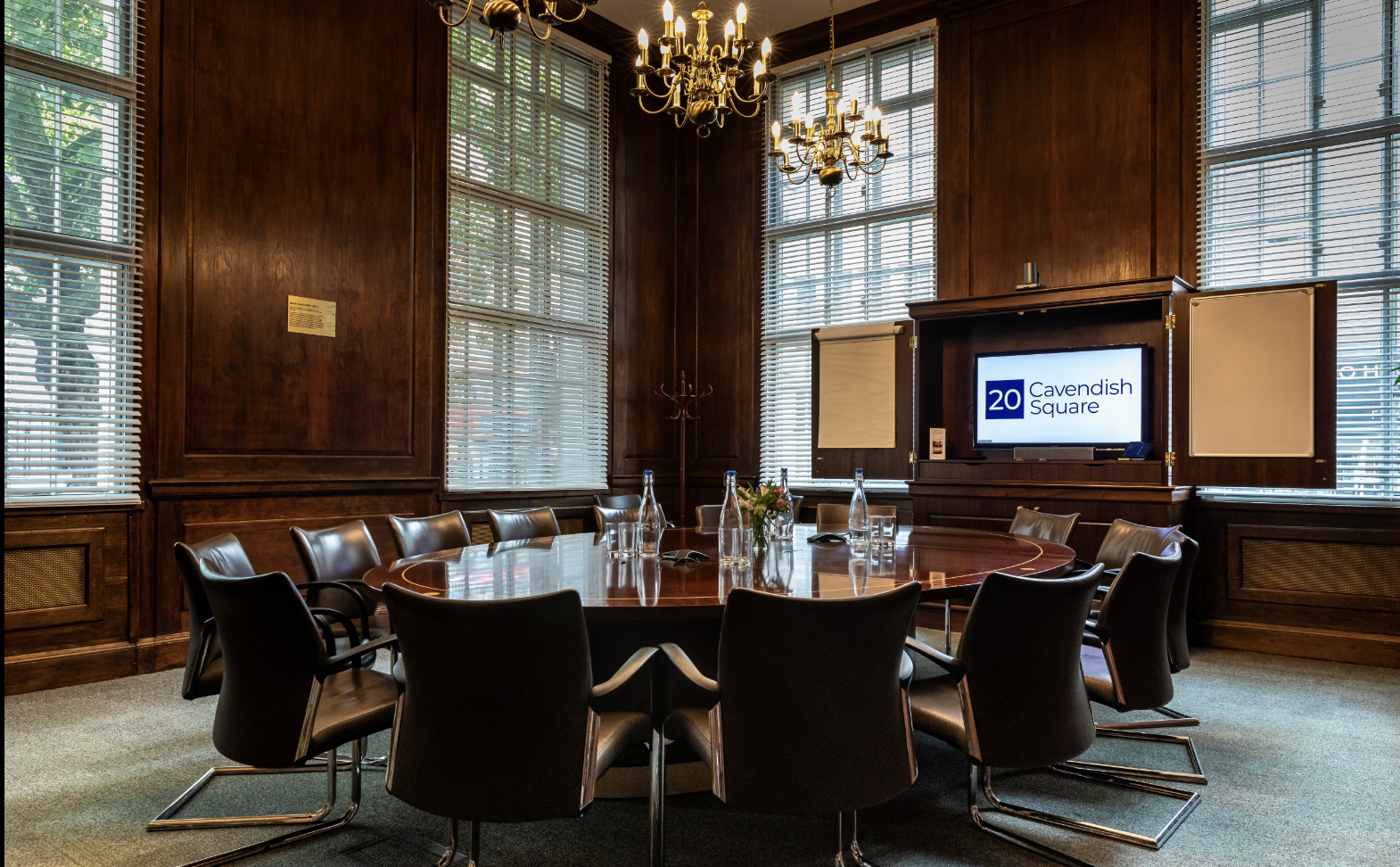 Sophisticated boardroom with round table for corporate meetings and events.