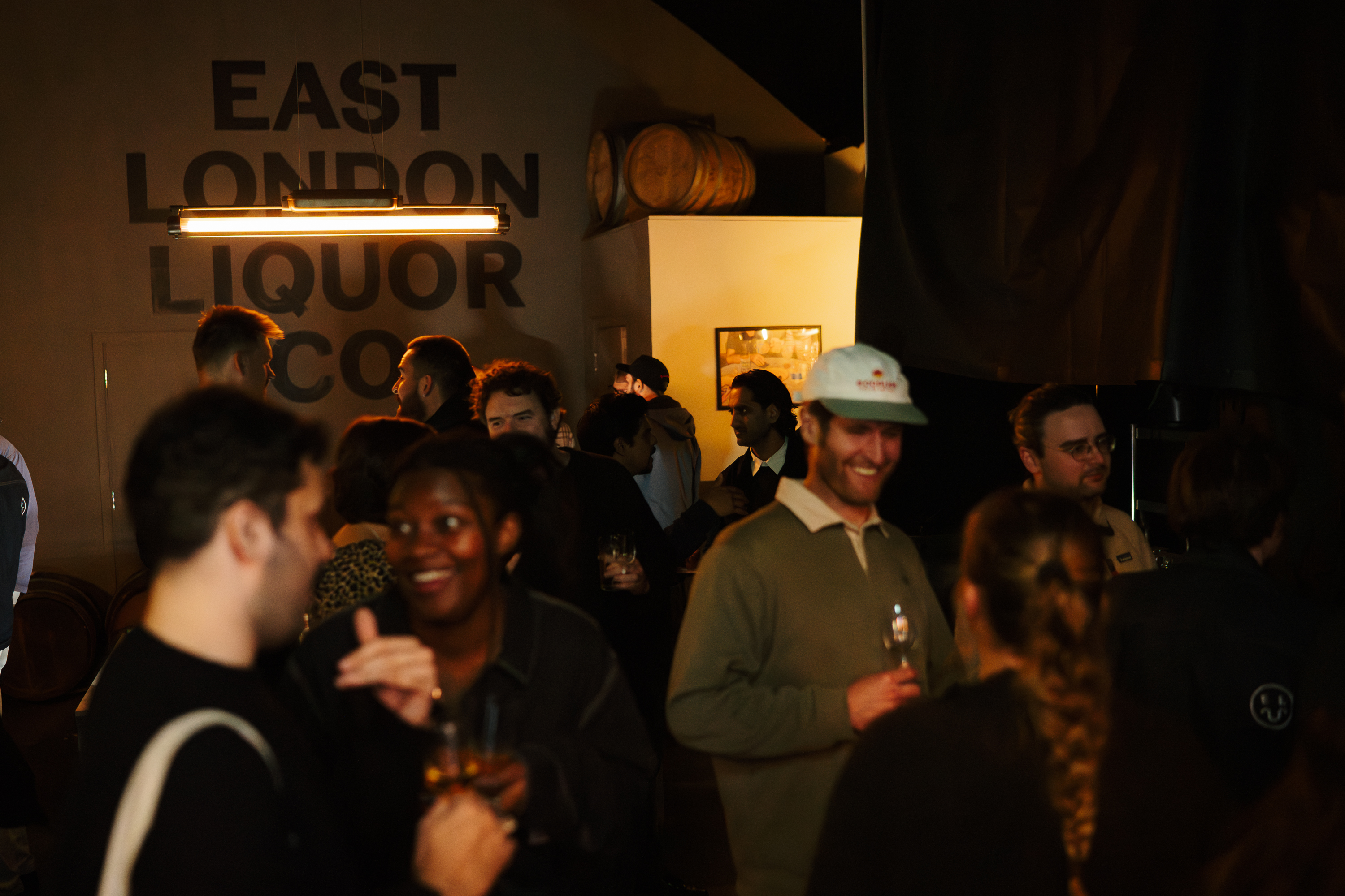 Lively networking event at East London Liquor Co Taproom with warm lighting.