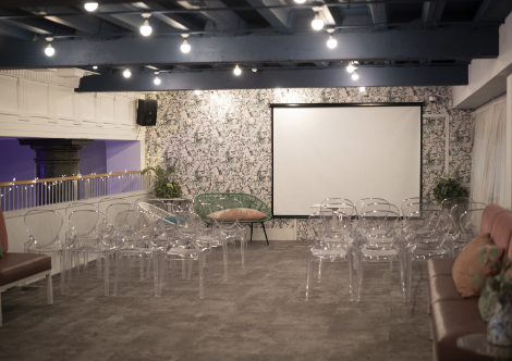 Sophisticated event space with transparent chairs for workshops and meetings.