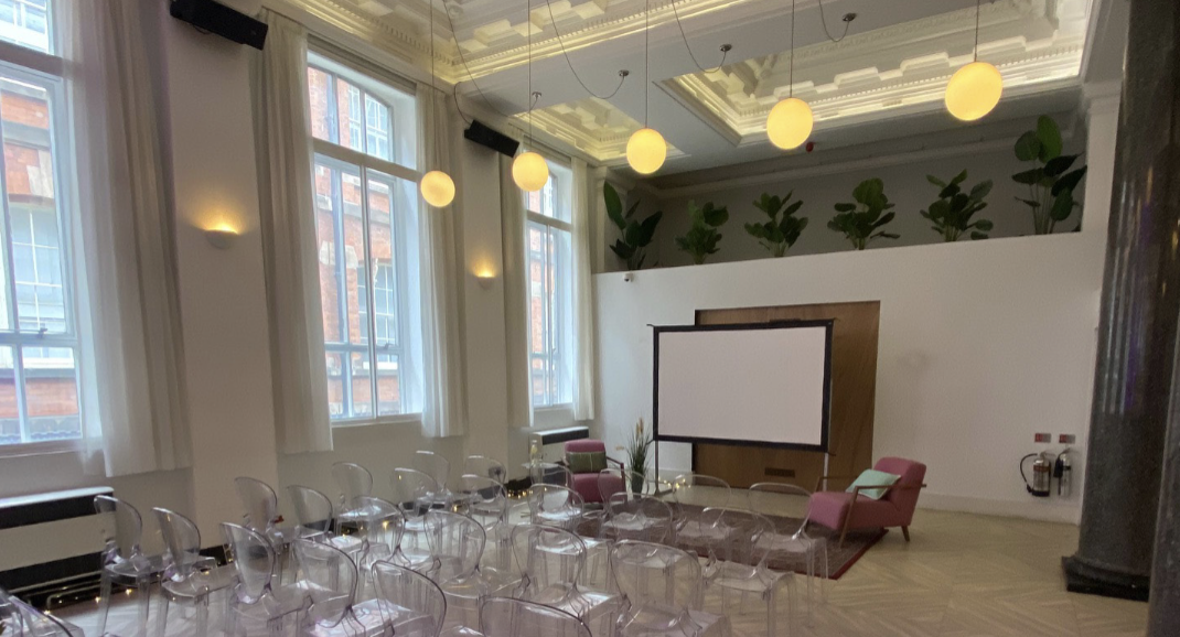 Modern meeting space with transparent chairs for presentations and events.