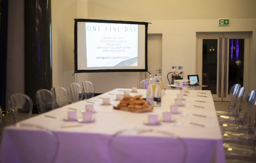 Main Event Space meeting room with elegant table setup for corporate workshops and discussions.
