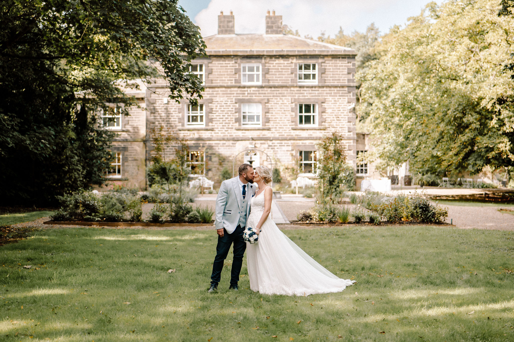 "Charming historic wedding venue at Coach House & Manor in Shotton Grange, lush greenery"