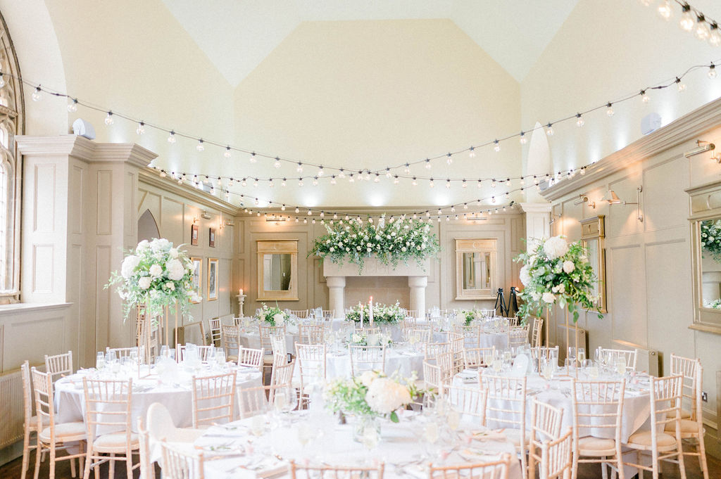 Elegant banquet hall at Enchanted Chapel, romantic wedding venue with floral centerpieces.