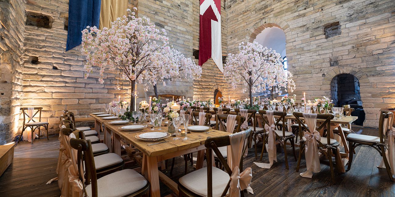 Elegant banquet table with cherry blossoms in Newton Hall for weddings and formal dinners.