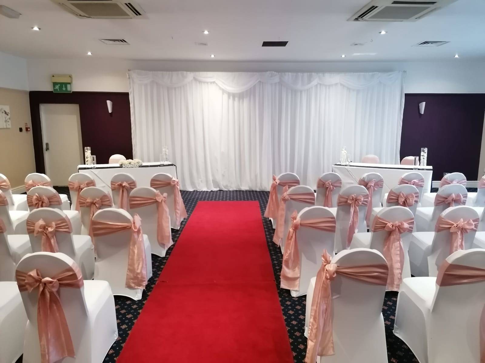 Function Suites & Great Hall in Newton Hall, elegant wedding venue with pink satin sashes.