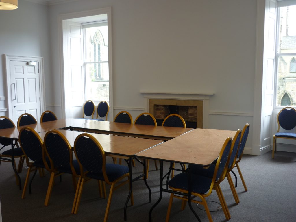 Spacious Great Hall in Hexham Abbey with U-shaped table for meetings and events.