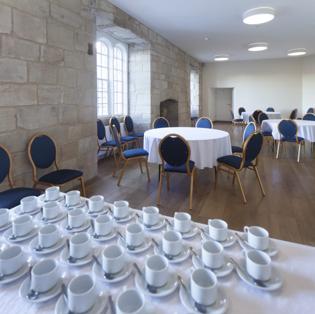 Great Hall in Hexham Abbey, elegant meeting space setup for events with natural light.