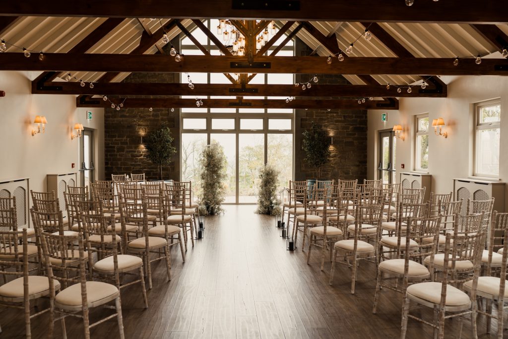 Rustic-chic wedding ceremony setup in Marshall Meadows Manor House Main Suite with Chiavari chairs.