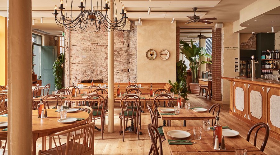 Inviting Casa Mayfair restaurant with rustic wood tables for events and gatherings