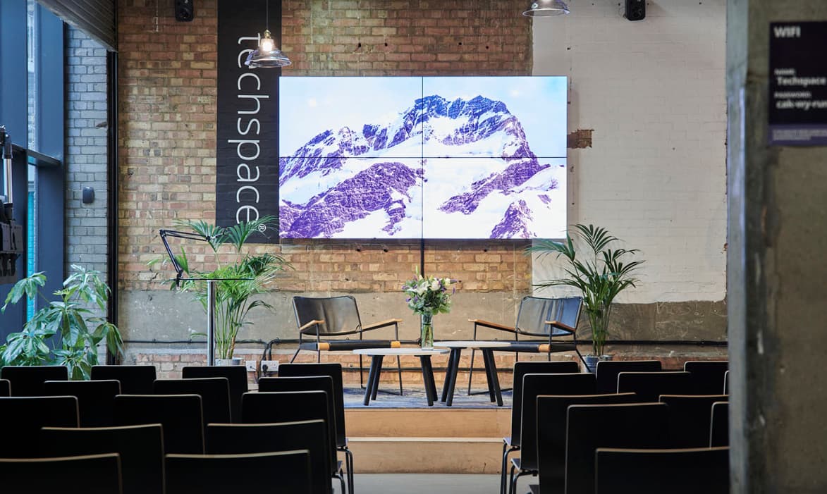 Fireside chat stage at The Loading Bay tech space with industrial branding for panel discussions.
