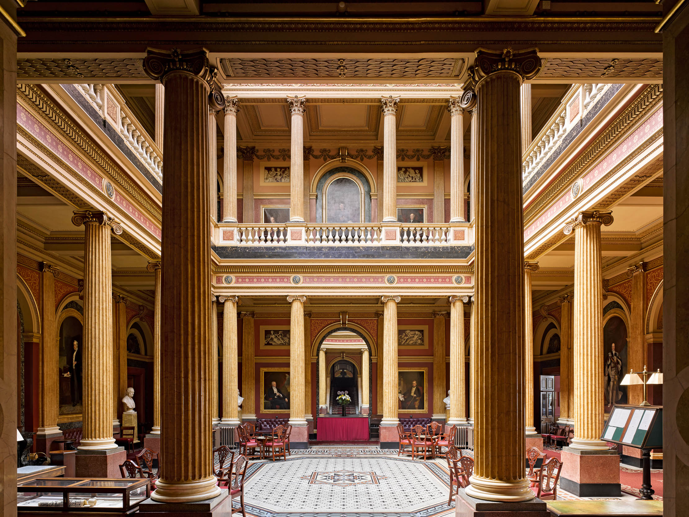 Grand library in The Reform Club, featuring ornate columns for upscale events and conferences.