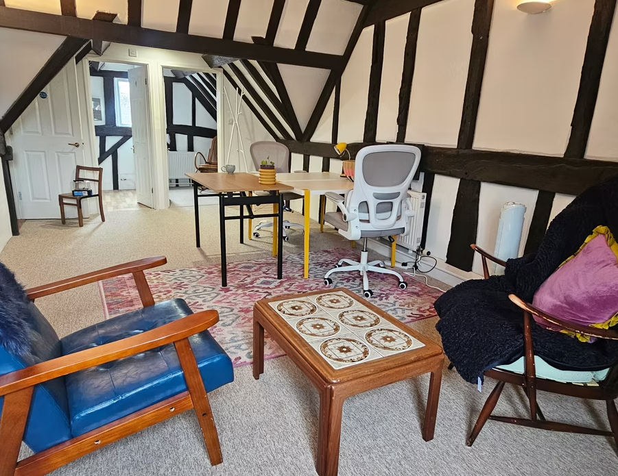 White swan meeting space with cozy seating, ideal for workshops and team building events.