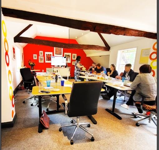 Red in Buick Mackane at a collaborative meeting space for brainstorming and teamwork.