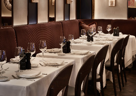 Elegant restaurant with polished tables, ideal for corporate dinners and intimate events.