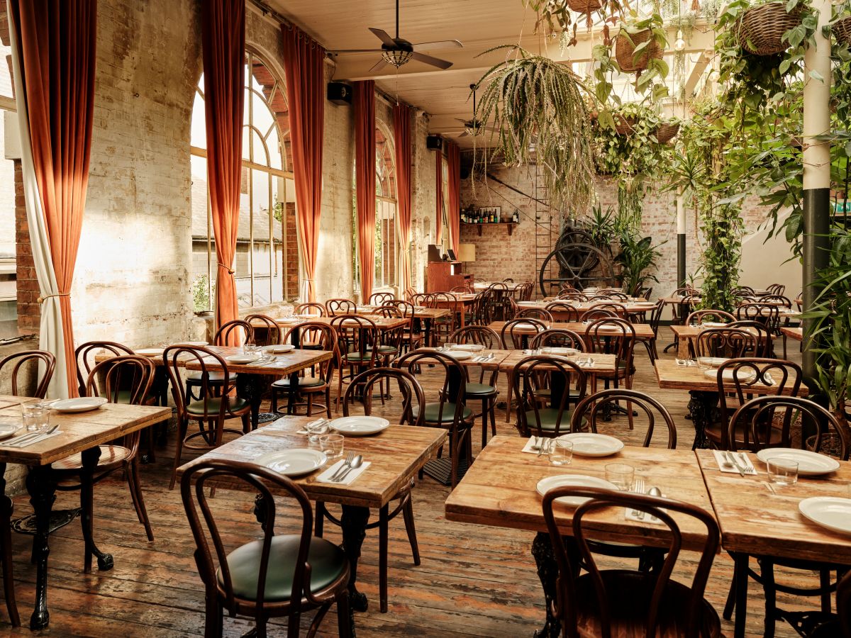 Full Venue Hire at Casa do Frango: rustic dining space for events with greenery.