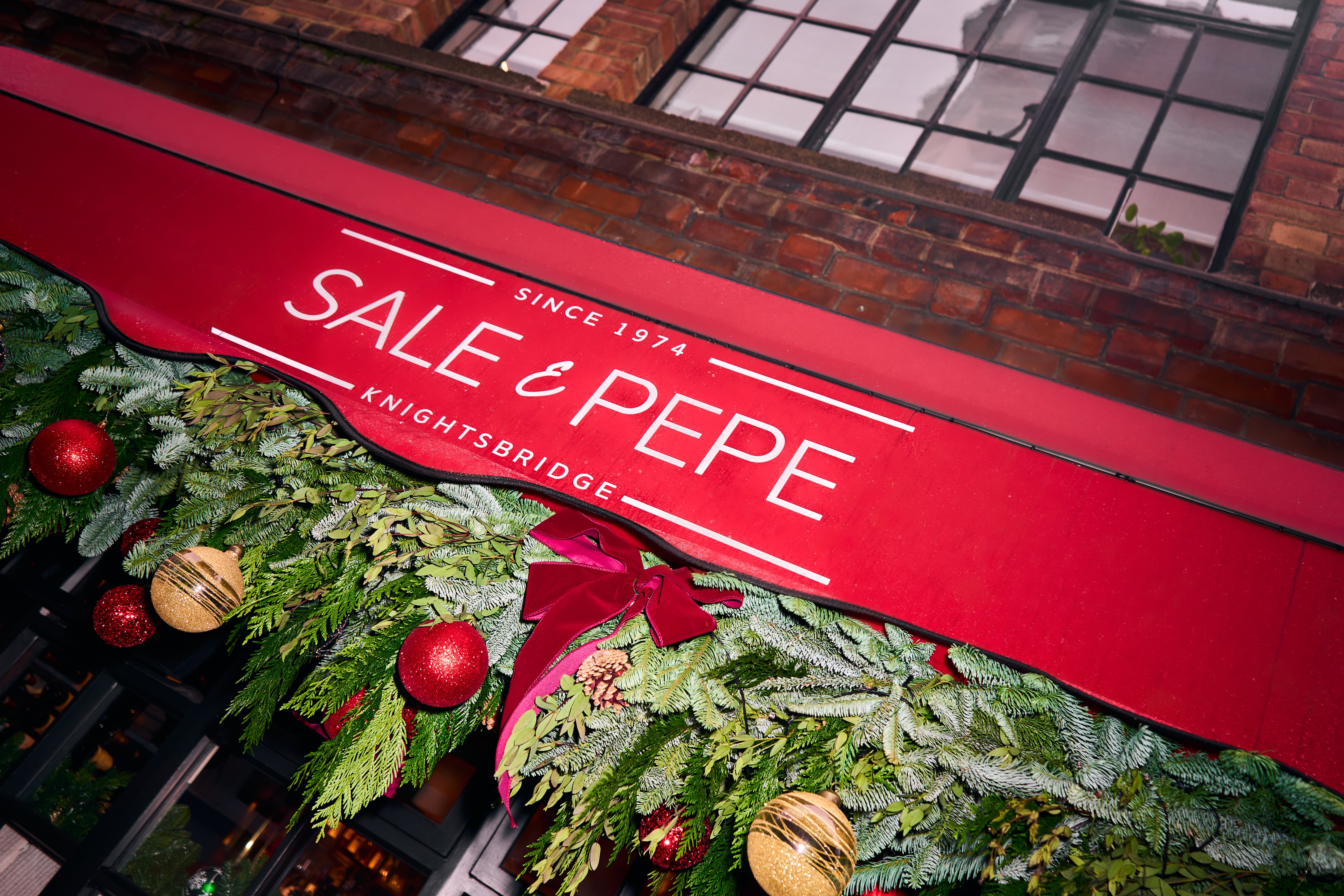 Festive entrance at Sale e Pepe Knightsbridge for corporate dinners and holiday networking events.