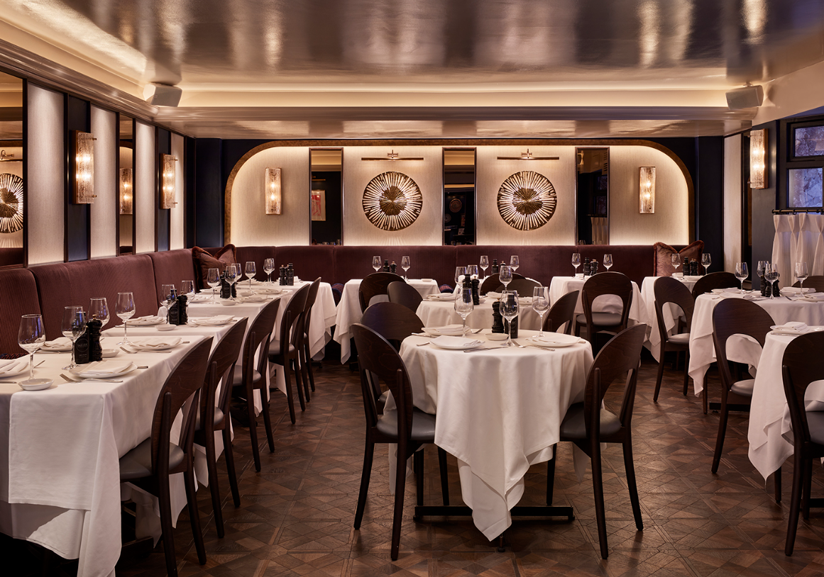 Sophisticated restaurant interior with elegant table settings for corporate events.