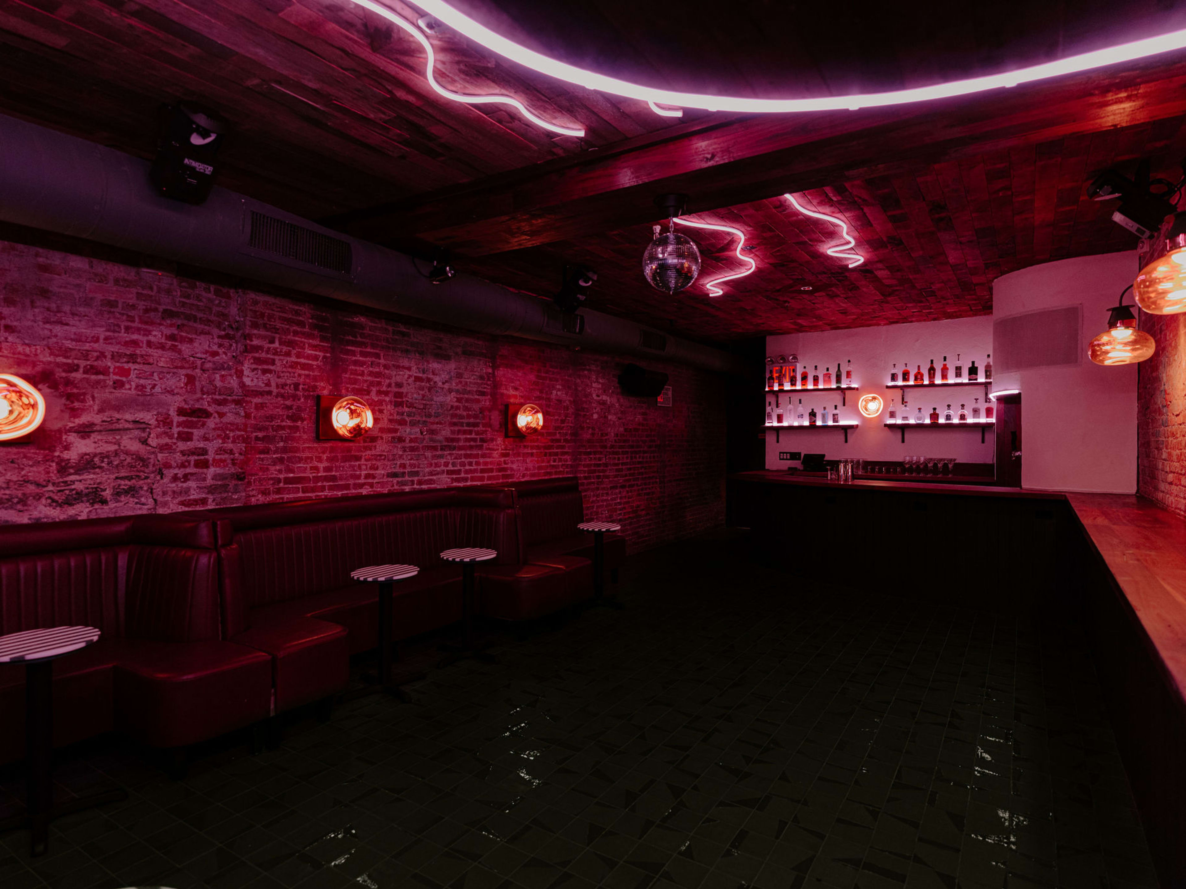 Trendy District Lounge with exposed brick walls, perfect for cocktail receptions and private events.