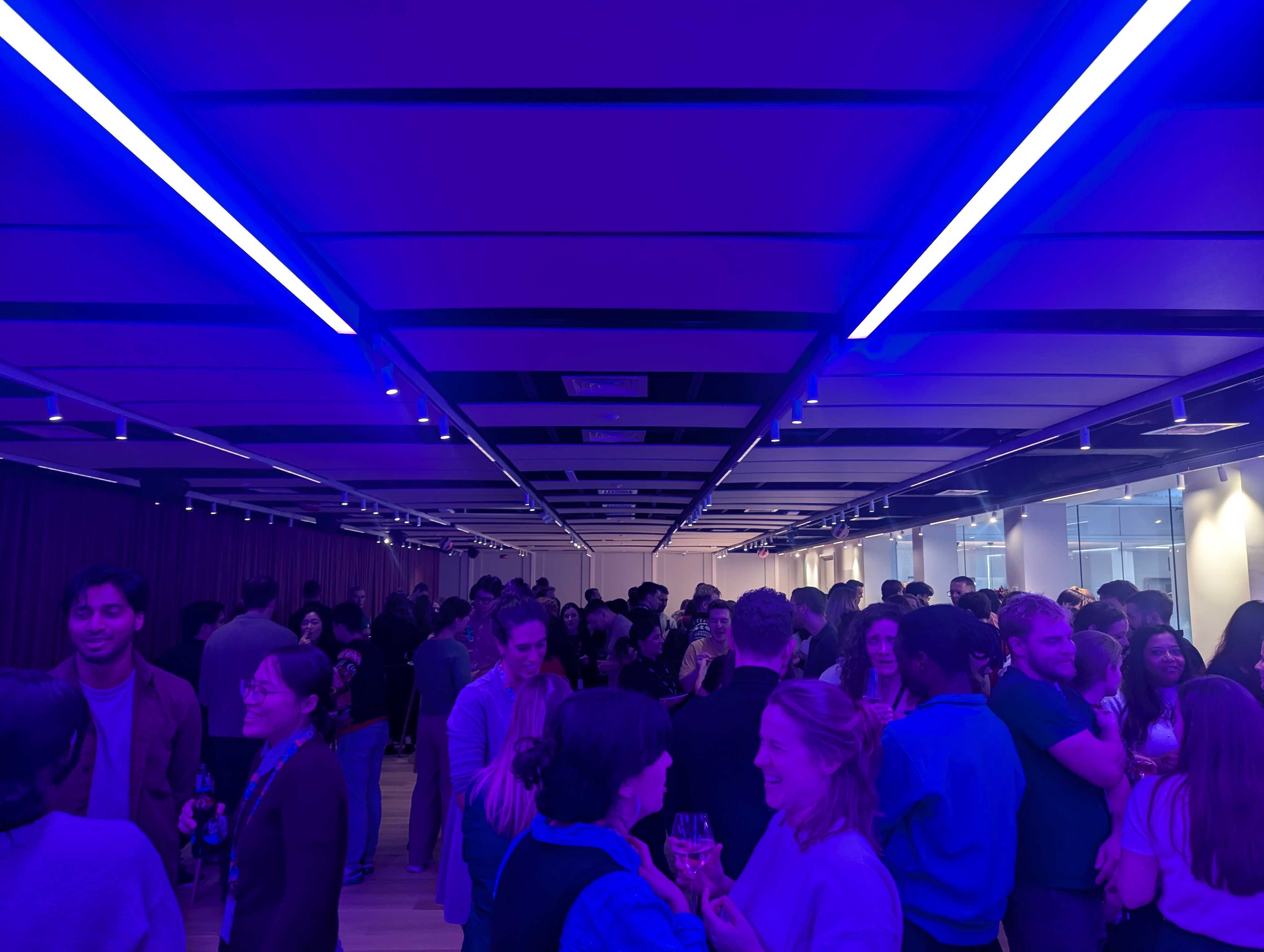 Vibrant networking event at The View in 58VE with ambient blue lighting.
