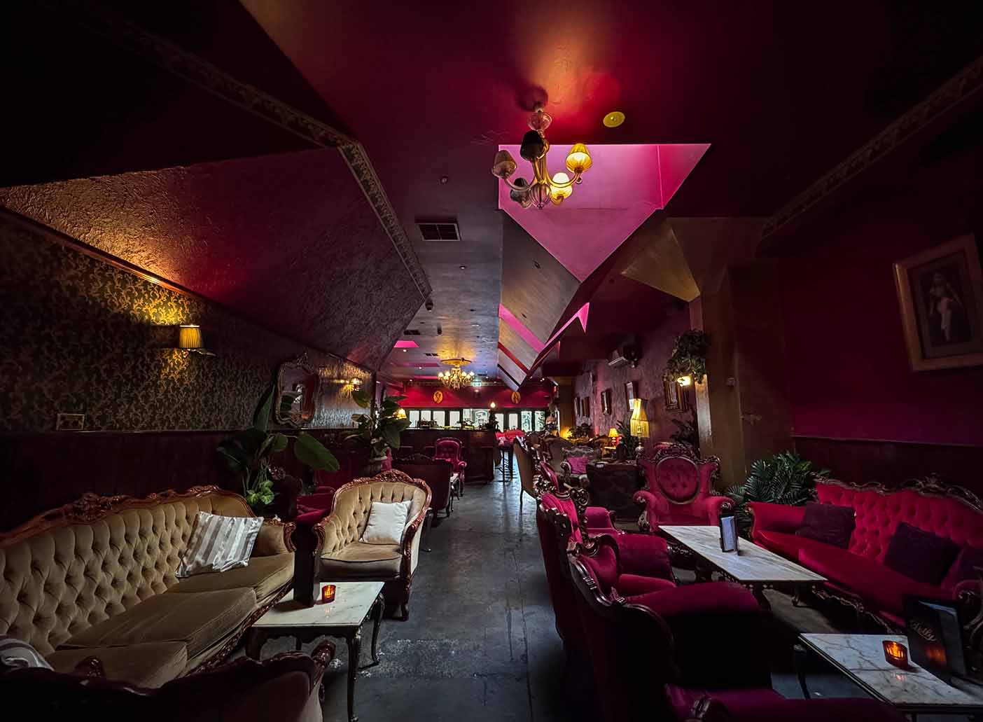 Private function room at Polly Bar with rich, red decor for upscale events and gatherings.
